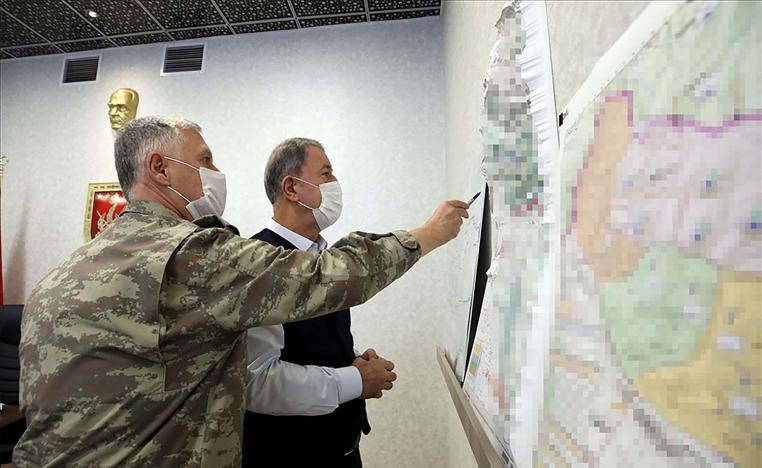 Turkish Minister of Defence Hulusi Akar (R) 