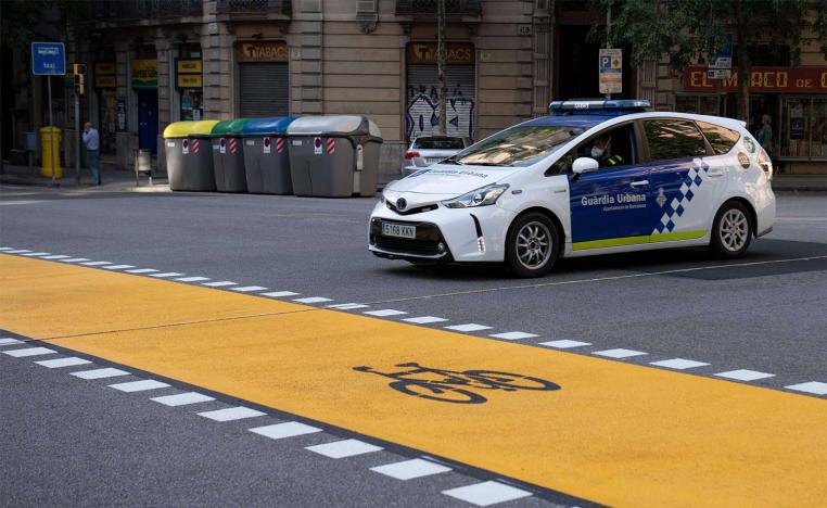 A local police car drives in Barcelona