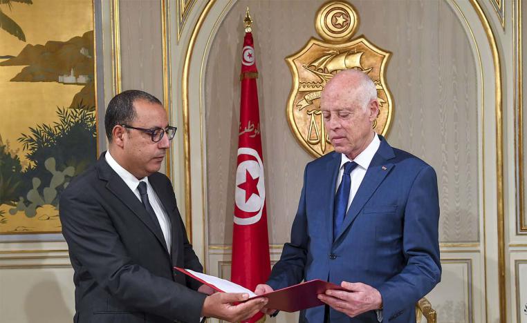 Tunisia's Prime Minister-designate Hichem Mechichi (L) presenting his cabinet list for Tunisian President Kais Saied (R) in Carthage palace