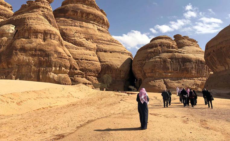Visitors walk outside the tombs at the Madain Saleh antiquities site, al-Ula, Saudi Arabia