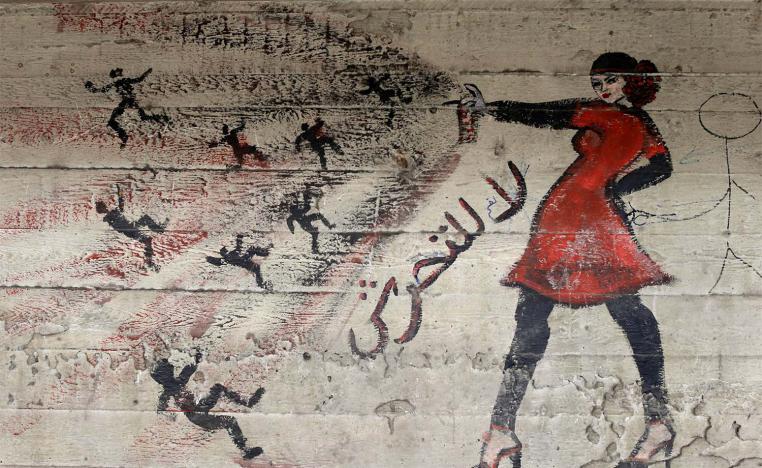 A mural with Arabic that reads "no to harassment," is seen on a wall in Cairo