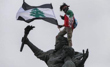 محتج لبناني يعتلي تمثال الشهداء وسط بيروت