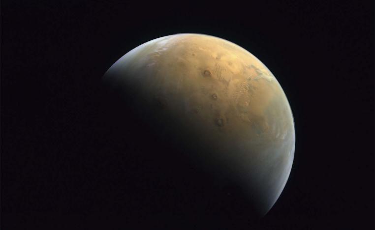 The image shows Mars' north pole, as well as Mars' largest volcano, Olympus Mons