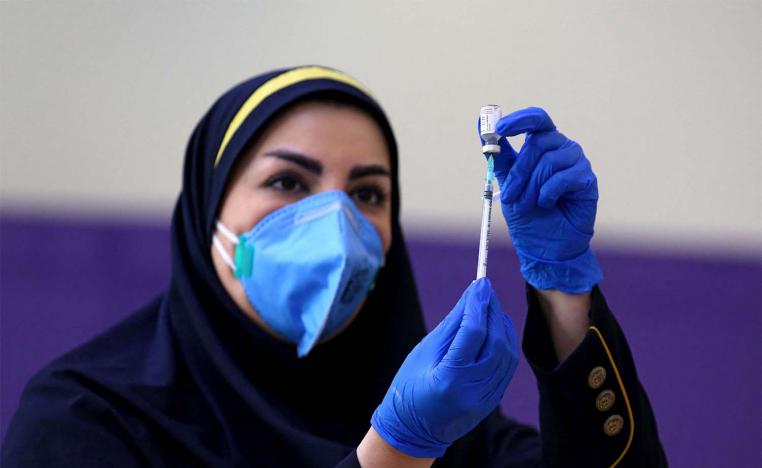 Iranian health worker prepares an injection of the locally-made COVID-19 vaccine
