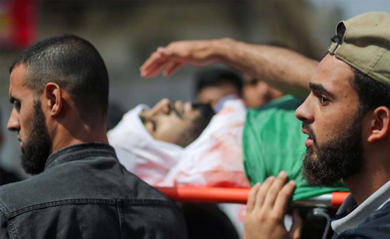Mourners carry the body of Palestinian man killed by Israeli airstrikes