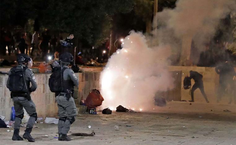 Tear gas billows amid clashes between Israeli security forces and Palestinian protesters at the al-Aqsa mosque compound