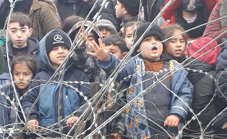 Migrants children gather near the fence on the Poland/Belarus border near Kuznica, Poland