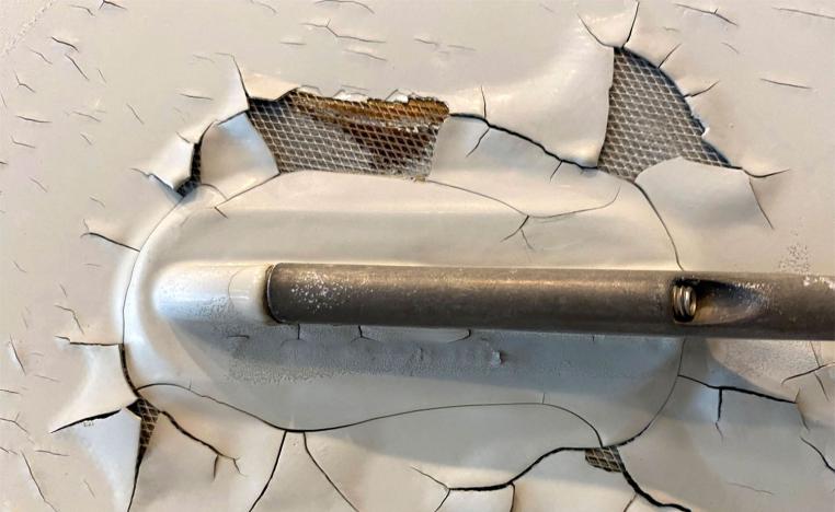 Paint peeling, cracking and exposed expanded copper foil on the fuselage of a Qatar Airways Airbus A350 aircraft