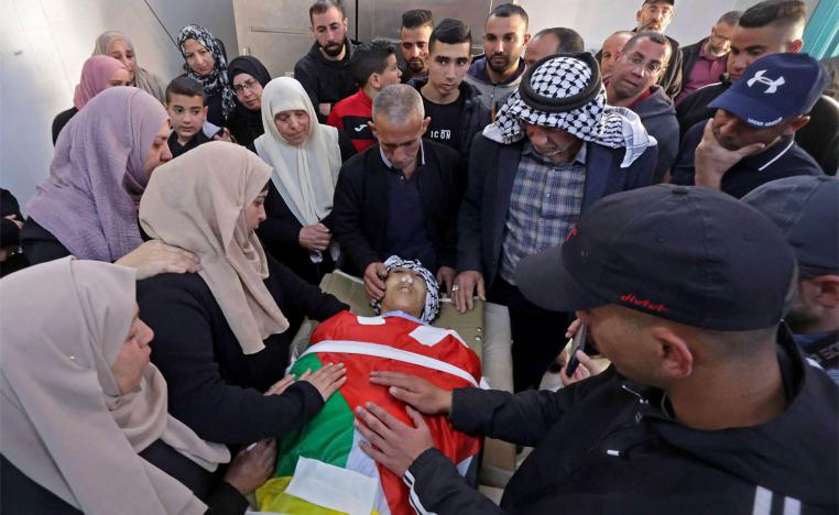 Parents of 16-year-old Palestinian Qusai Hamamrah mourn over his body during his funeral in the village of Husan, north of Bethlehem 