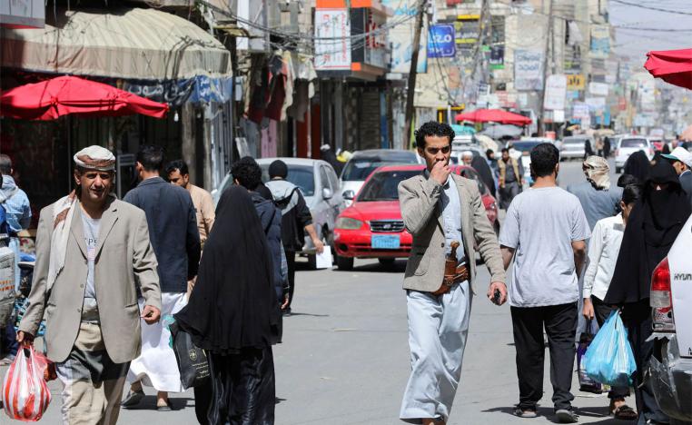 People walk on a street hours before a two-month nationwide truce takes effect in Sanaa