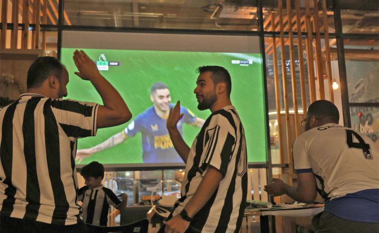 Saudi fans of Newcastle United celebrate a goal scored against Tottenham 
