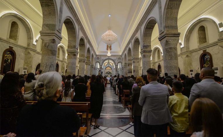 Iraqi Catholic Christians attending Easter Sunday mass at Qaraqosh's Al-Tahera (Immaculate Conception) Church in the Hamdaniyah district in the northern Iraqi province of Nineveh last April