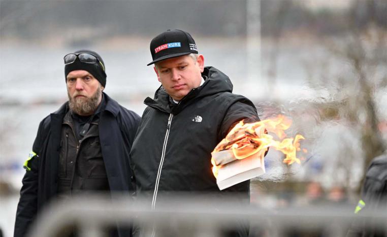 An anti-immigrant politician from the far-right fringe burned a copy of the Koran near the Turkish Embassy in Stockholm