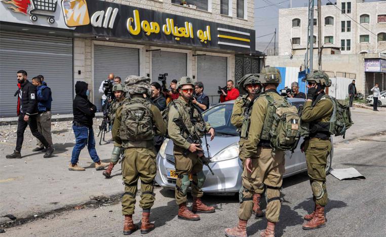 Israeli troops began removing settlers from a previously evacuated settlement outpost near the West Bank city of Nablus