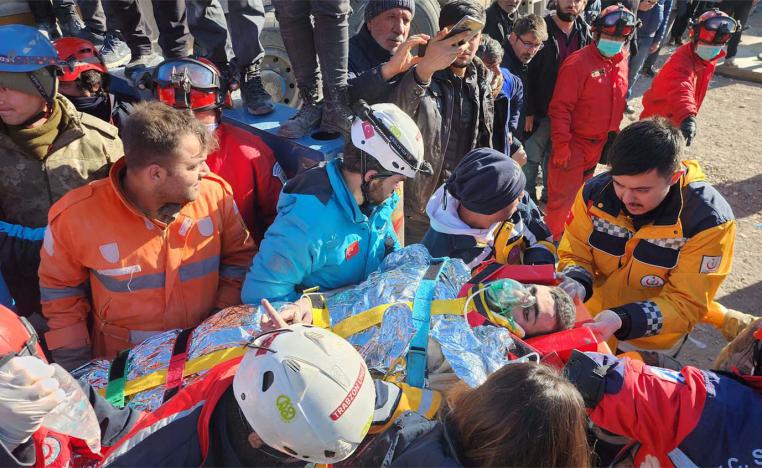 Rescue workers carrying Cafer strapped on a stretcher