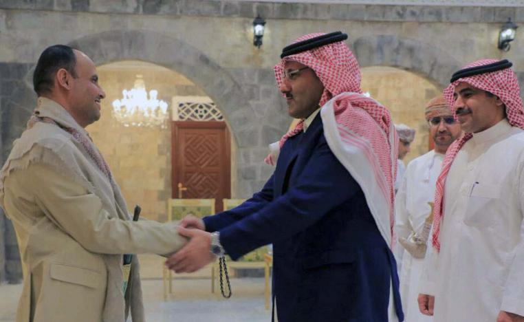 Houthis' political leader Mahdi al-Mashat (L) welcoming the Saudi ambassador to Yemen Mohammed Al Jaber