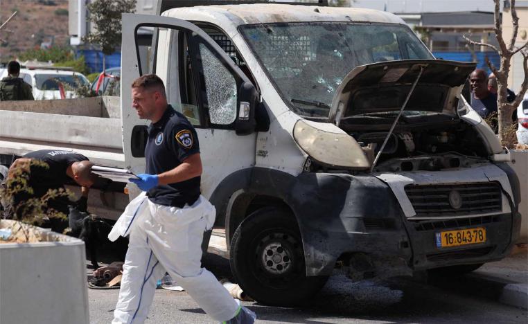 Israeli forensic inspect a truck next to a checkpoint outside the Palestinian village of Nilin