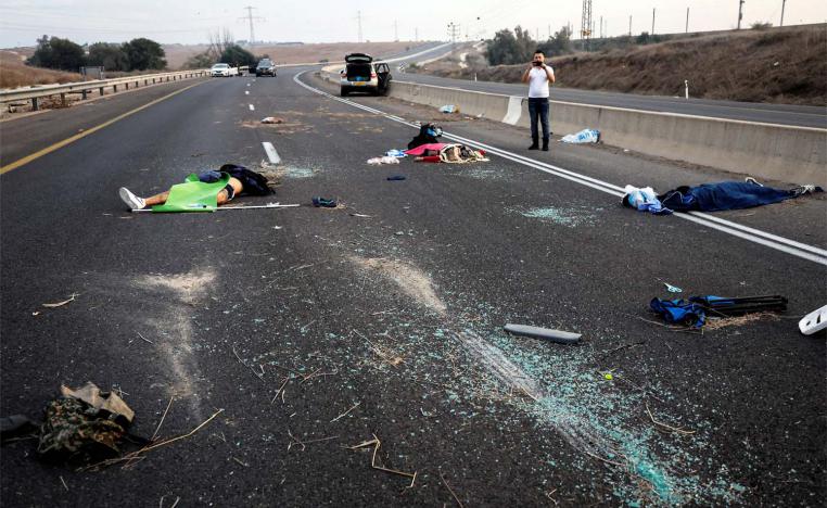 Dead people strewn across a road following a mass-infiltration by Hamas gunmen in the Sderot area