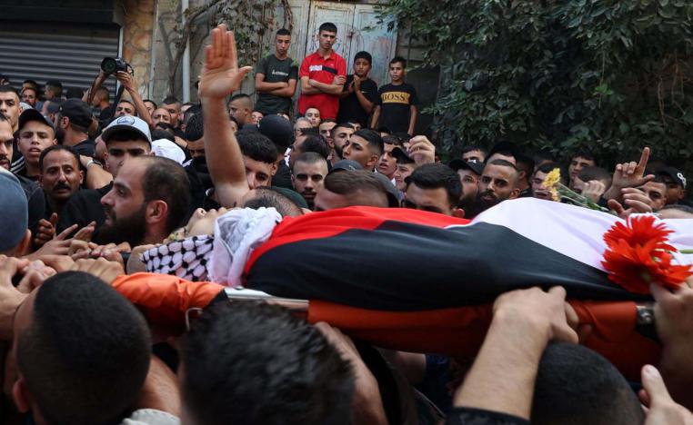 Mourners carry the body of Usayed Hmaidat, a Palestinian youth killed during during a reported Israeli raid on the refugee camp of al-Jalazon near Ramallah 