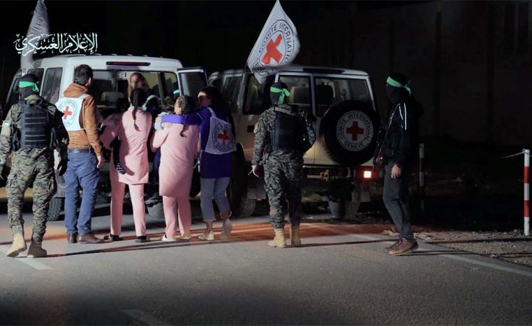Hostages who were abducted by Hamas gunmen during the October 7 attack on Israel,are handed over by Hamas militants to ICRC members