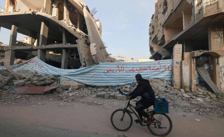 لافتة تشير إلى وجود جثامين لفلسطينيين تحت انقاض مبنى دمر في قصف إسرائيلي لرفح