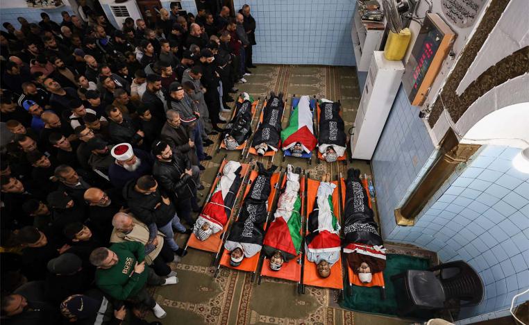 Relatives and friends pray over the bodies of Palestinians killed during a three-day incursion by the Israeli army on the Jenin camp