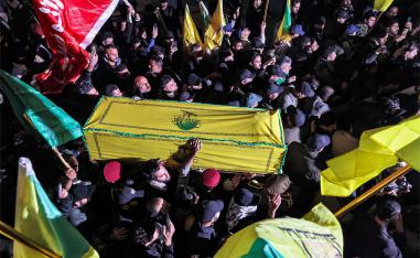 Members of Iraq's Popular Mobilisation Forces (PMF) paramilitaries carry the bodies of two of their slain comrades during their funeral in Baghdad