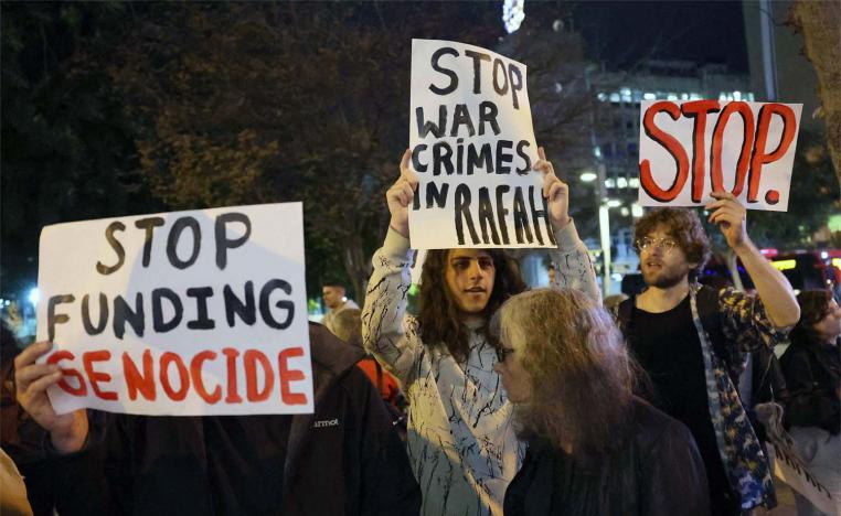Demonstrators gather with signs during a protest by Israeli left-wing activists against the war in the Gaza Strip 
