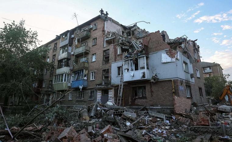 Rescuers work at a site of a residential building in kharkiv hit by a Russian missile strike