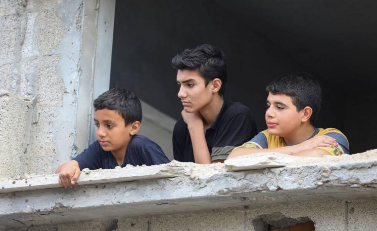 أطفال فلسطينيون في مبان مهدمة بسبب القصف الإسرائيلي في غزة