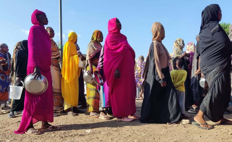 Displaced Sudanese queue for food aid at a camp in the eastern city of Gedaref