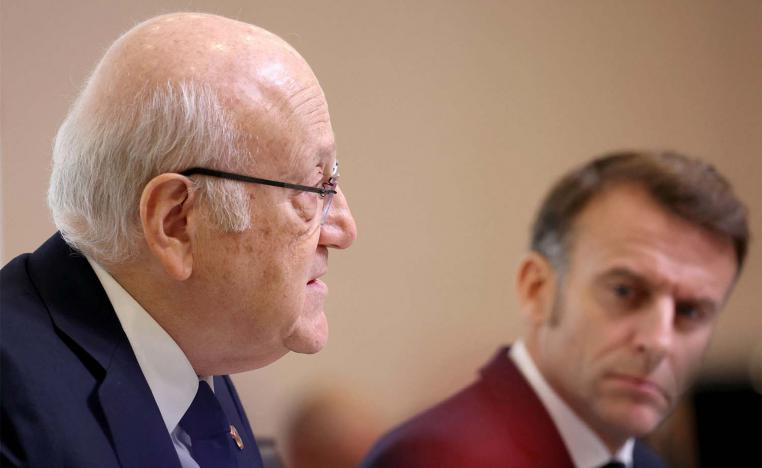 Lebanon's PM Najib Mikati (L) speaks next to Frances President Emmanuel Macron