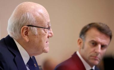 Lebanon's PM Najib Mikati (L) speaks next to Frances President Emmanuel Macron