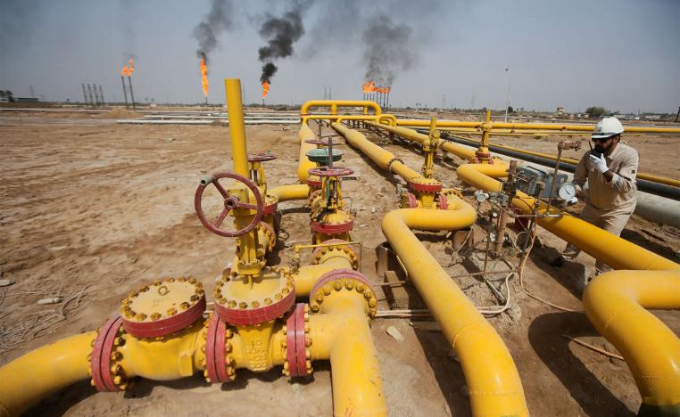 A worker checks an oil pipeline at Nahr Bin Umar oil field, north of Basra