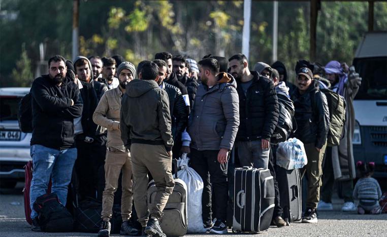 Syrian refugees who lives in Turkey wait with their belongings at Cilvegozu crossborder gate before entering in Syria