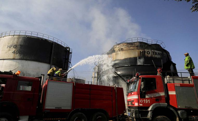 irefighters extinguish fire at a power station following Israeli airstrikes in Sanaa,
