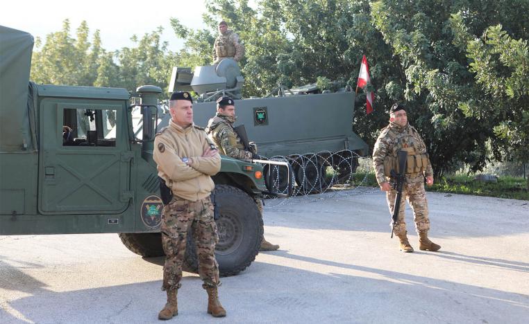 Lebanese soldiers stand at the entrance of Deir Mimas