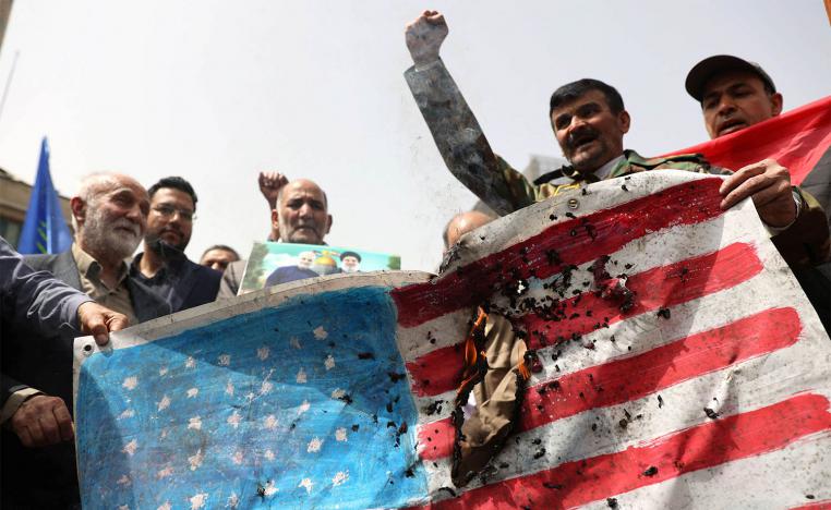 Iranians burn a US flag during a gathering in support of Gaza, in Tehran