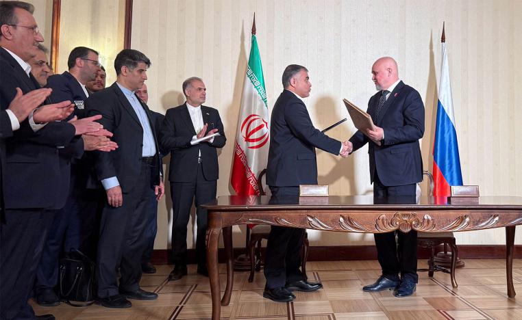 Russian Energy Minister Sergei Tsivilev and Iranian Oil Minister Mohsen Paknejad exchange documents during a signing ceremony in Moscow