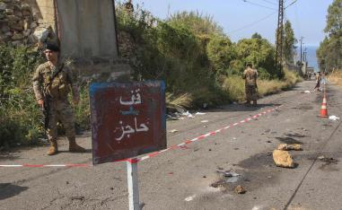 Lebanese security forces set up a checkpoint on the road leading to the scene of an Israeli airstrike in Baawert on April 22