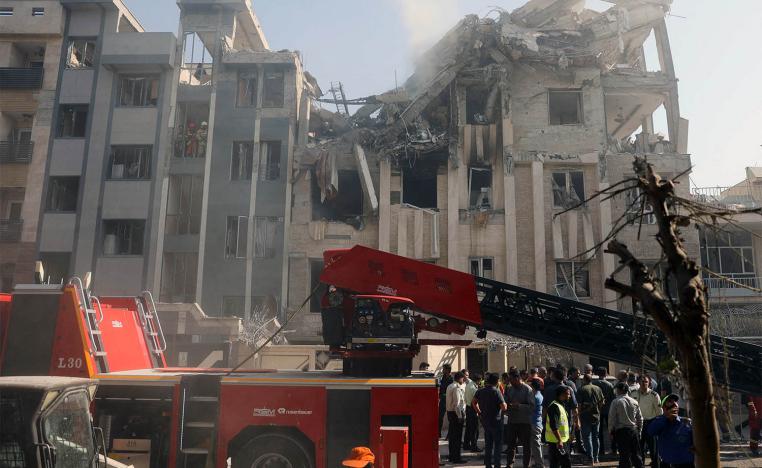 Rescuers work at the scene of a damaged building in the aftermath of Israeli strikes, in Tehran