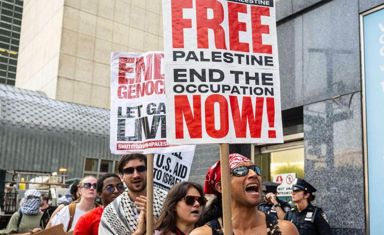 People participate in a protest in support of Palestine outside the UN as a conference on Palestine and a two-state solution takes place inside the UN 