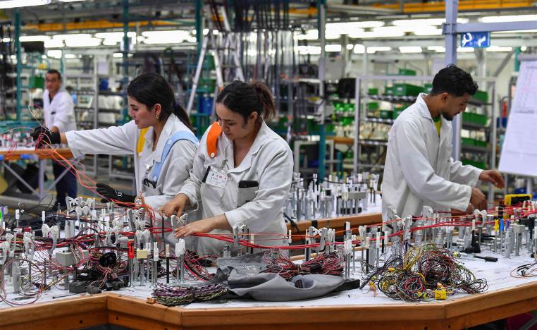 Employees work in a cable factory of the German company Draxlmaier, specialized in the manufacture of automotive components, in Jemmal city in Monastir, Tunisia