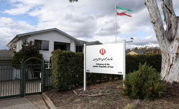 An Iranian flag flutters outside the Iran Embassy in Australia