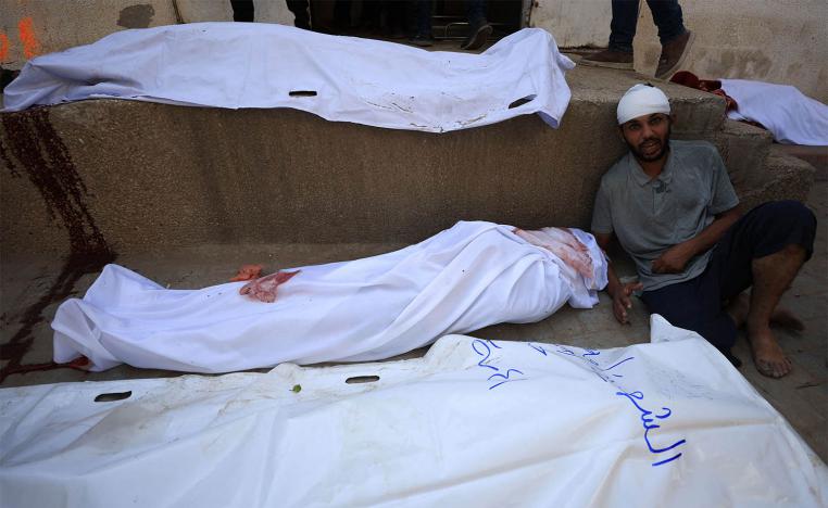 A mourner reacts during the funeral of Palestinians killed in overnight Israeli strikes at Al-Shifa Hospital in Gaza City