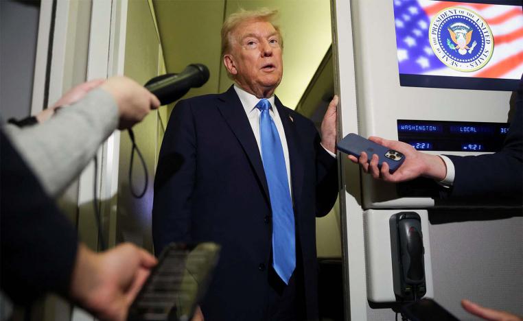 Trump speaks to the media aboard Air Force One 