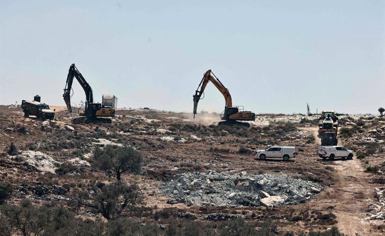 Israeli bulldozers destroying houses in the occupied West Bank