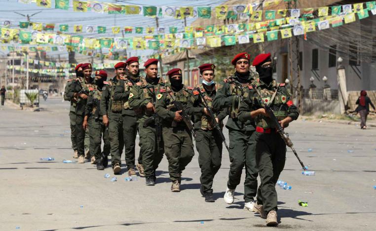 Armed members of the Syrian Democratic Forces (SDF) military police take part in a demonstration under the banner “With our will, we will protect our revolution,” in Qamishli, Syria, September 17, 2025. 
