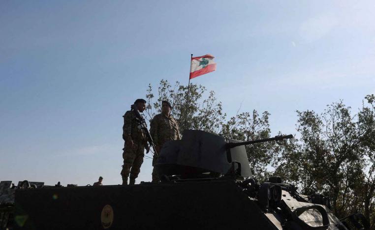 Lebanese army members stand on a military vehicle in the southern Litani sector, in Alma Al-Shaab, near the border with Israel, southern Lebanon, November 28, 2025. 