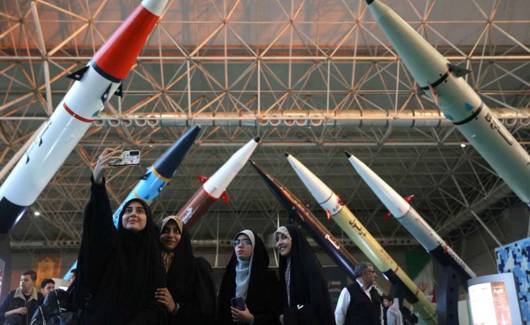 Women take a selfie at the Islamic Revolutionary Guard Corps (IRGC) Aerospace Force Museum in Tehran, November 12, 2025. 